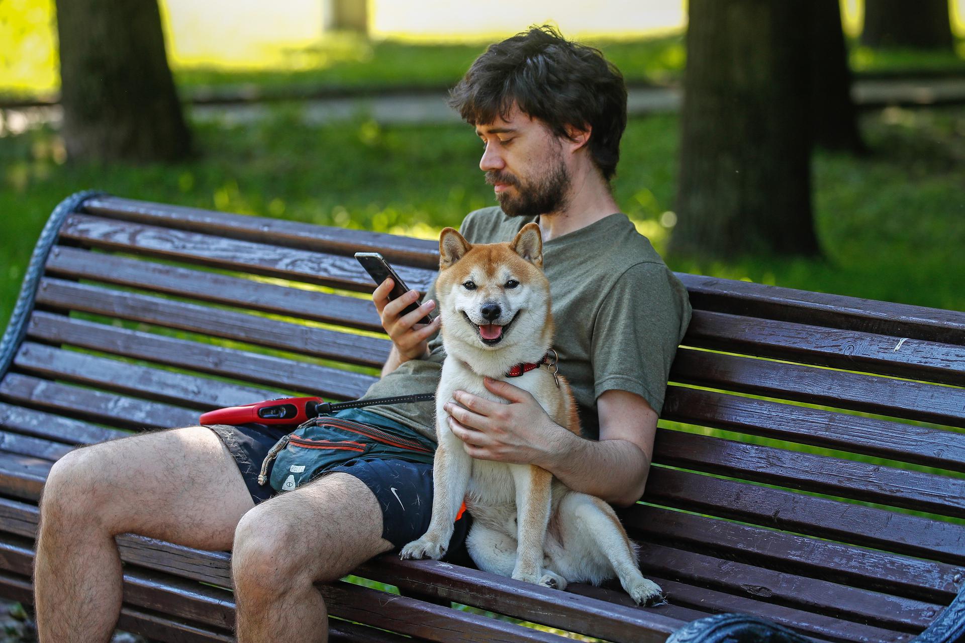 Man with a Dog on a Bench
